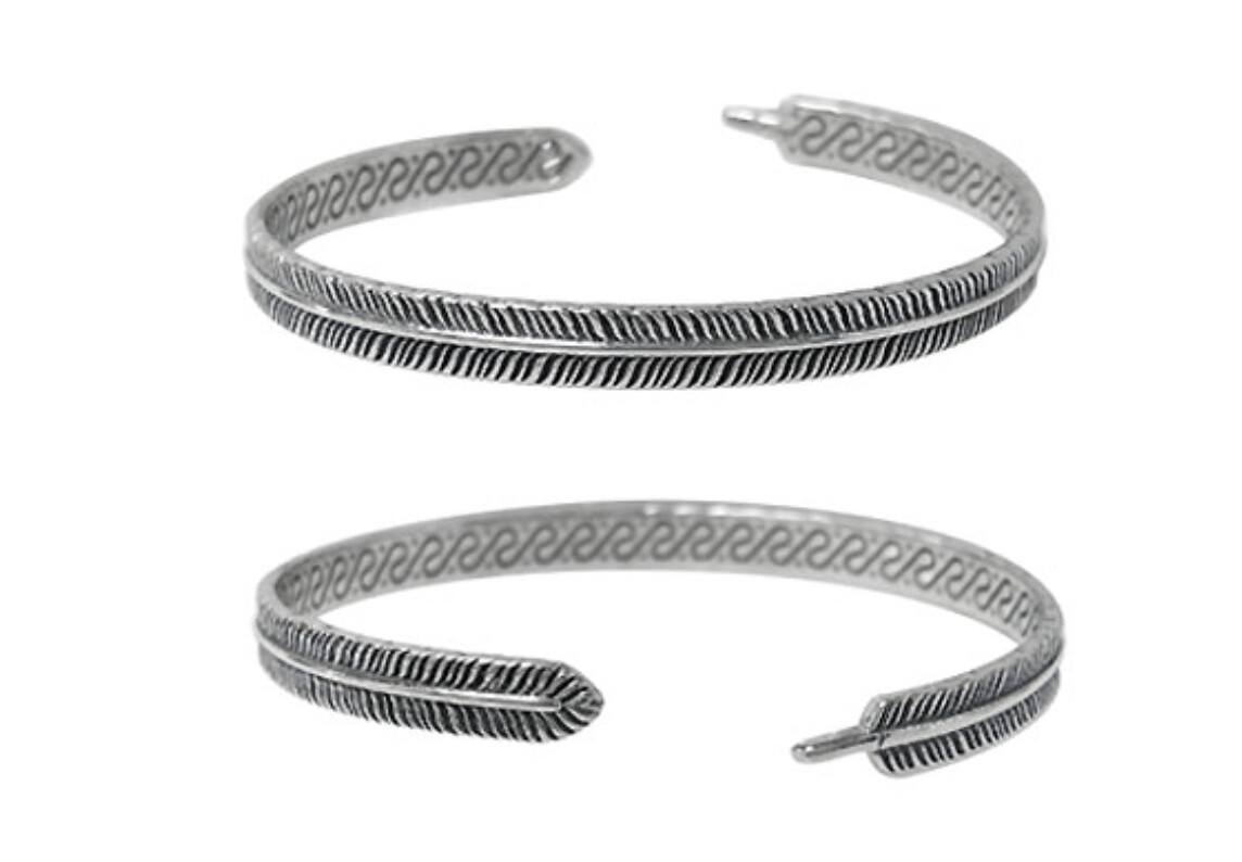 Sterling silver, detail feather bangle. Approx size: 5mm width