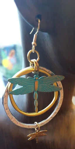 Asymmetrical brass dragonflies