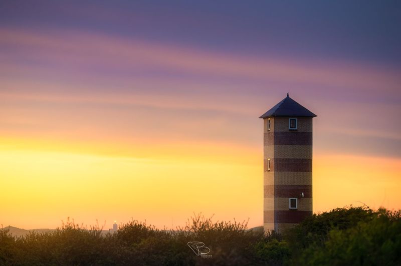 Vuurtoren Dishoek onder kleurrijke lucht