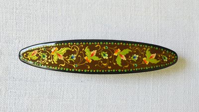 Stunning floral hand painted barrette on a brown background
