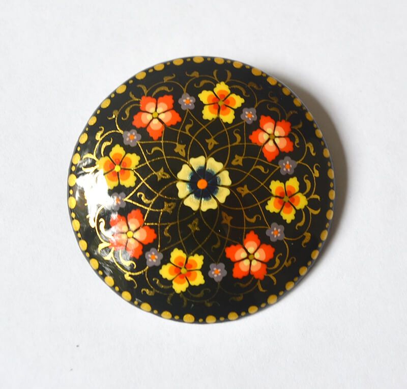 Sophisticated Floral Lapel Pin With Gold Leaf Details On A Classic Black Background