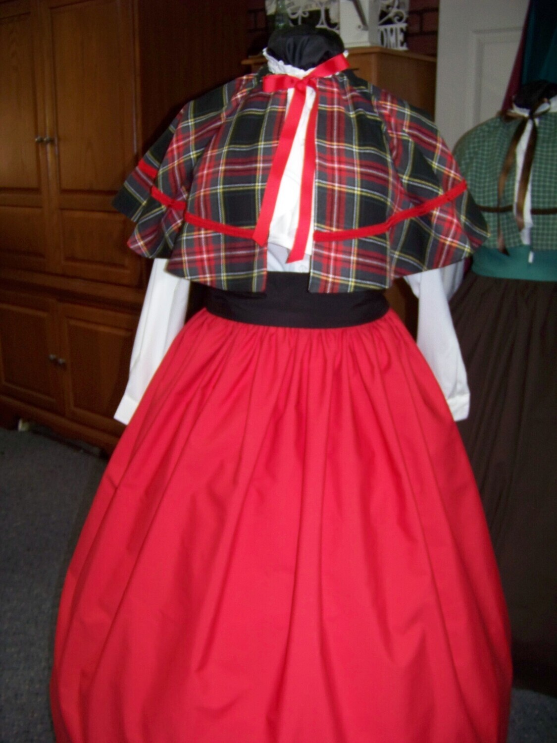 Mrs. Claus or Christmas Caroler costume long red drawstring SKIRT with red, black, yellow and white cotton homespun plaid cape with red braid and black cotton sash one size fits most. Handmade USA