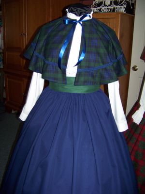 Dicken's Christmas Caroler cape Navy blue and black and green Plaid cape reversible Navy blue solid on back one size fits most with Navy blue Skirt and green sash