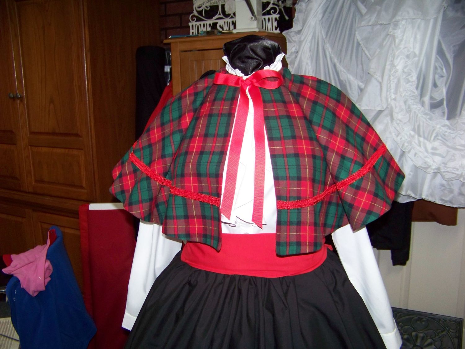 Dicken&#39;s Christmas Caroler cape Red and black and green Plaid cape reversible red solid on back one size fits most with Black Skirt and red sash