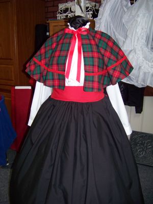 Dicken's Christmas Caroler cape Red and black and green Plaid cape reversible red solid on back one size fits most with Black Skirt and red sash
