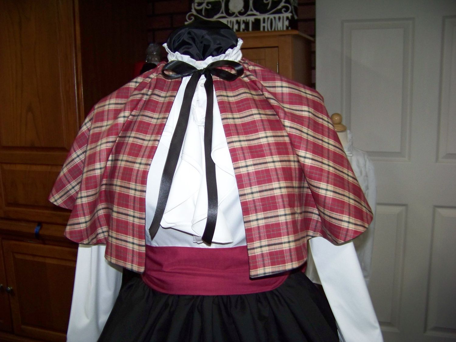 Dicken&#39;s Christmas Caroler cape Burgundy, green,beige and black  Plaid Homespun cape reversible with black on back one size fits most with Black Skirt and Burgundy sash. Handmade in USA