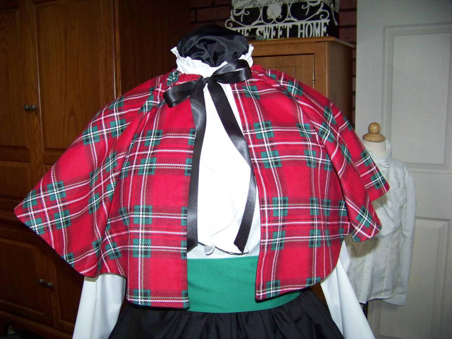 Dicken&#39;s Christmas Caroler cape Red, green, white and black Plaid Flannel cape reversible black solid on back one size fits most with Black Skirt and green sash. Handmade USA