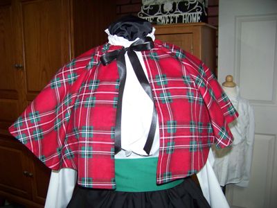 Dicken&#39;s Christmas Caroler cape Red, green, white and black Plaid Flannel cape reversible black solid on back one size fits most with Black Skirt and green sash. Handmade USA