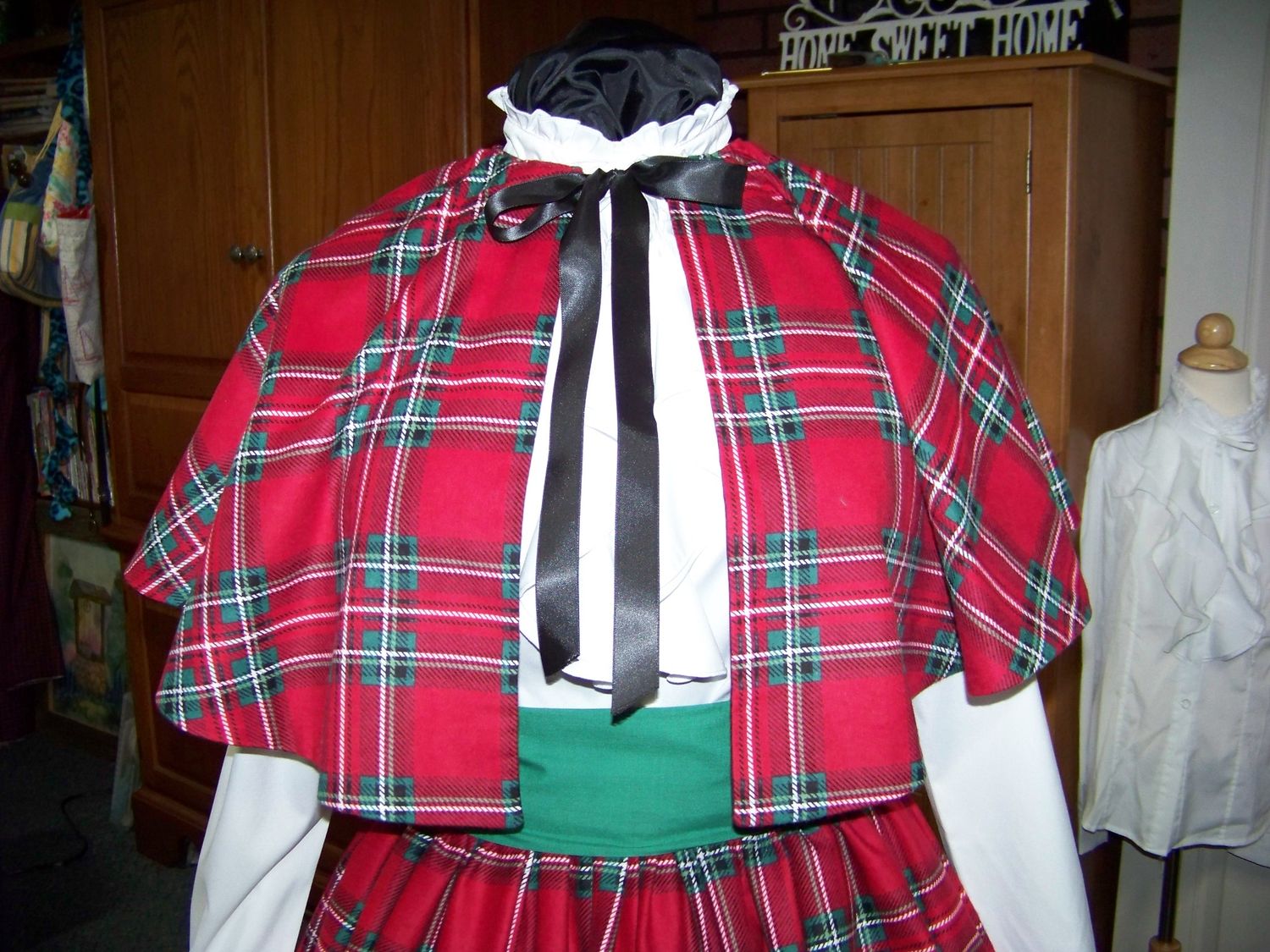 Dicken&#39;s Christmas Caroler cape Red, green, white and black Plaid Flannel cape reversible black solid on back one size fits most with matching Skirt and green sash. Handmade USA
