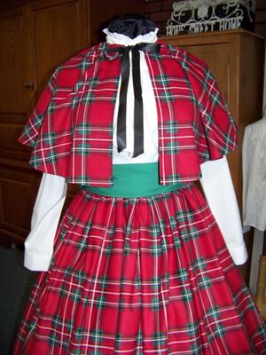 Dicken's Christmas Caroler cape Red, green, white and black Plaid Flannel cape reversible black solid on back one size fits most with matching Skirt and green sash. Handmade USA