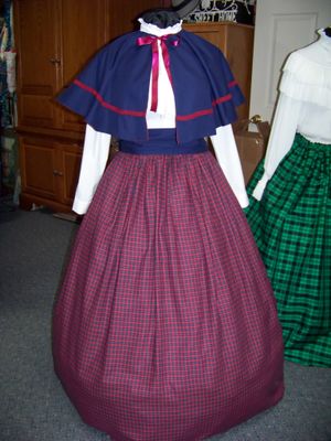 Dicken's Christmas Plus size 3-piece outfit and matching hat and purse. Navy-Blue, Cranberry and yellow check skirt with solid Navy-blue cape and Hat and Purse