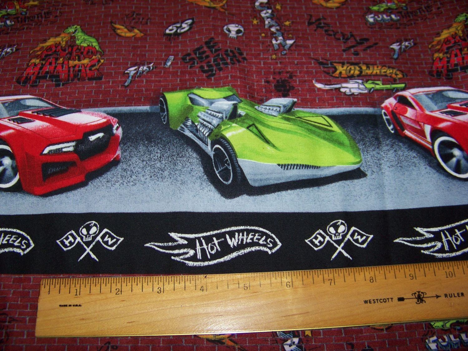Hot Wheels Car print border Fabric with bricks and graffiti background Red + green car great for boy room valance Cranston Village 3 1/2 yds