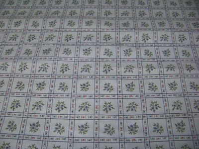 Lt. blue fabric with squares of flowers great for quilts, table clothes, pillows 45" and 8 yards