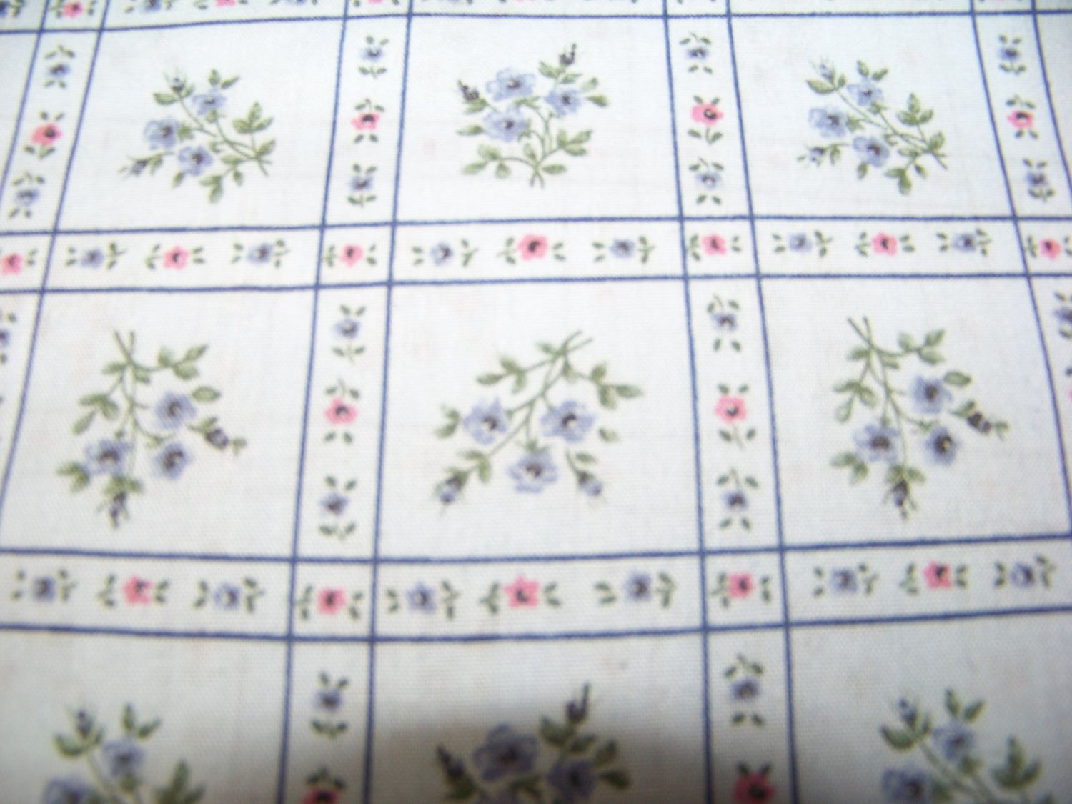 Lt. blue fabric with squares of flowers great for quilts, table clothes, pillows 45" and 8 yards
