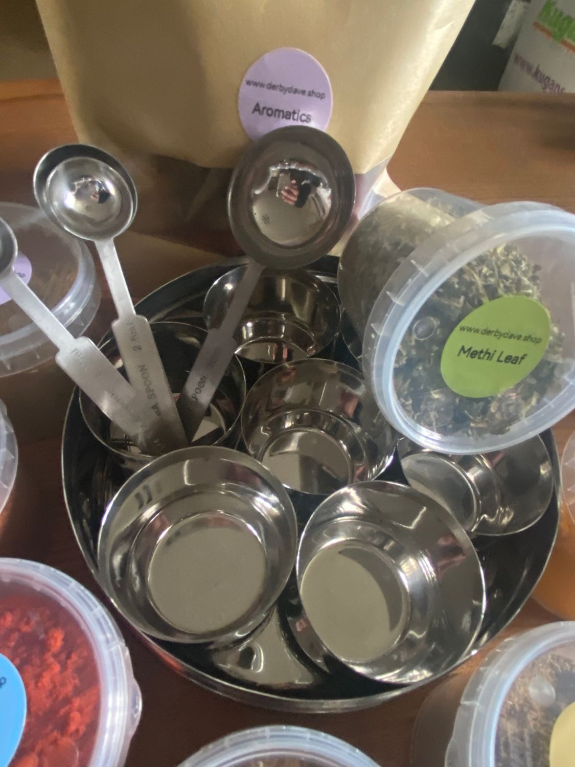 Small dabba with measuring spoons and spices