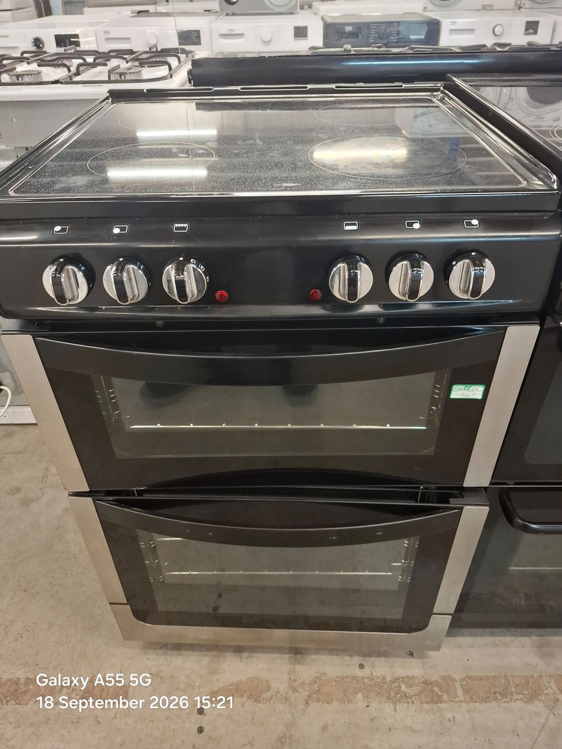 New World NW601E00 60cm Electric Cooker Double Oven Black and silver