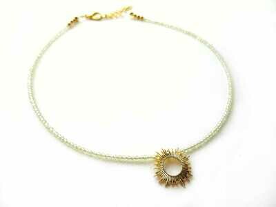 Peridot gemstone choker necklace with sun burst charm.