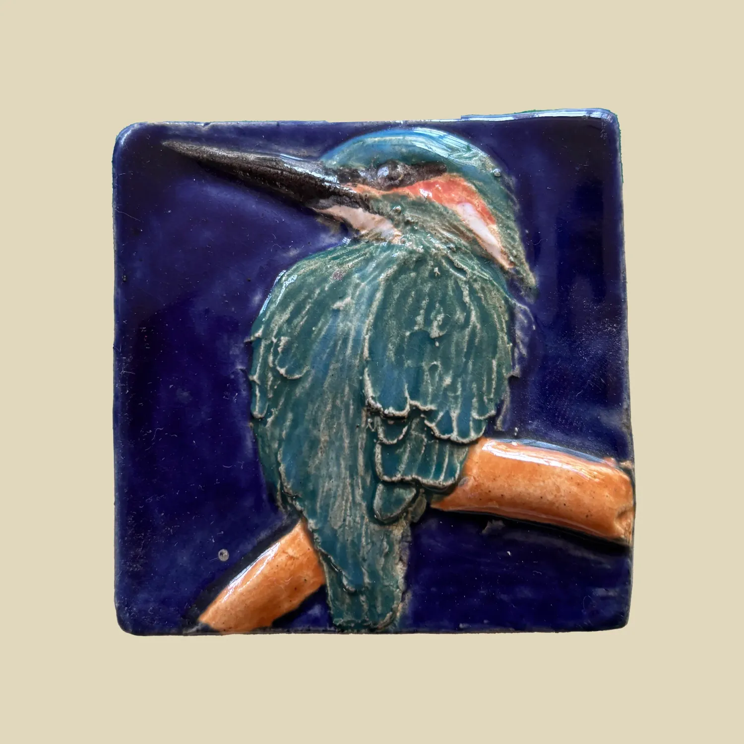 A stunning jade green kingfisher set against a dark blue background  6.5cm x 6.5cm