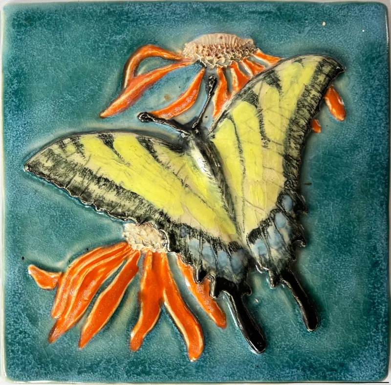 A ceramic feature tile, showing a yellow swallowtail butterfly set against a jade green background, 15cm x 15cm