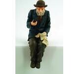 MAN SITTING WITH PIPE