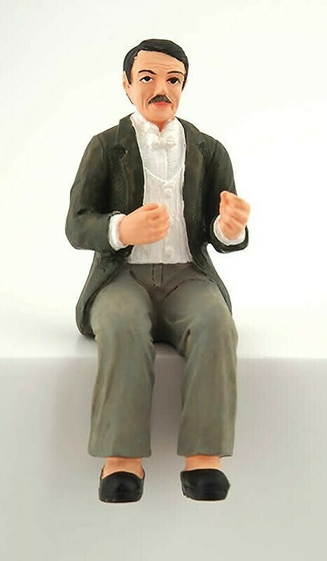 MAN SITTING IN EVENING DRESS