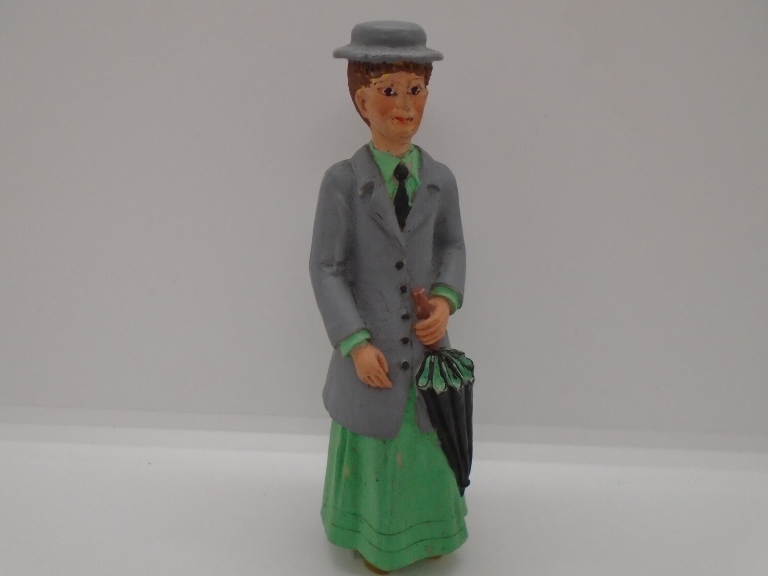 LADY IN GREEN WITH UMBRELLA