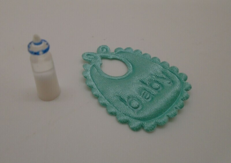 GREEN BIB AND BOTTLE OF MILK