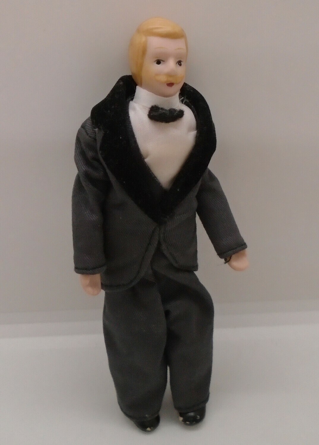 MAN IN GREY SUIT WITH BLONDE HAIR AND MOUSTACHE