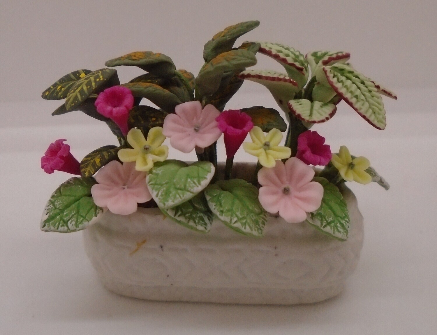 FLOWERS IN WHITE TROUGH