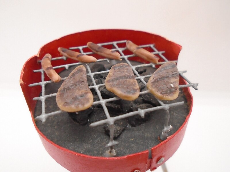 OPEN BBQ WITH COALS AND FOOD COOKING