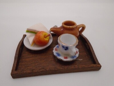 DRESSED TRAY WITH CUP OF TEA AND SANDWICHES AND APPLE
