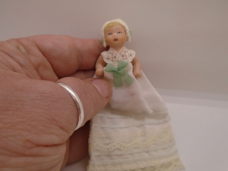 BABY IN CHRISTENING GOWN WITH GREEN BOW