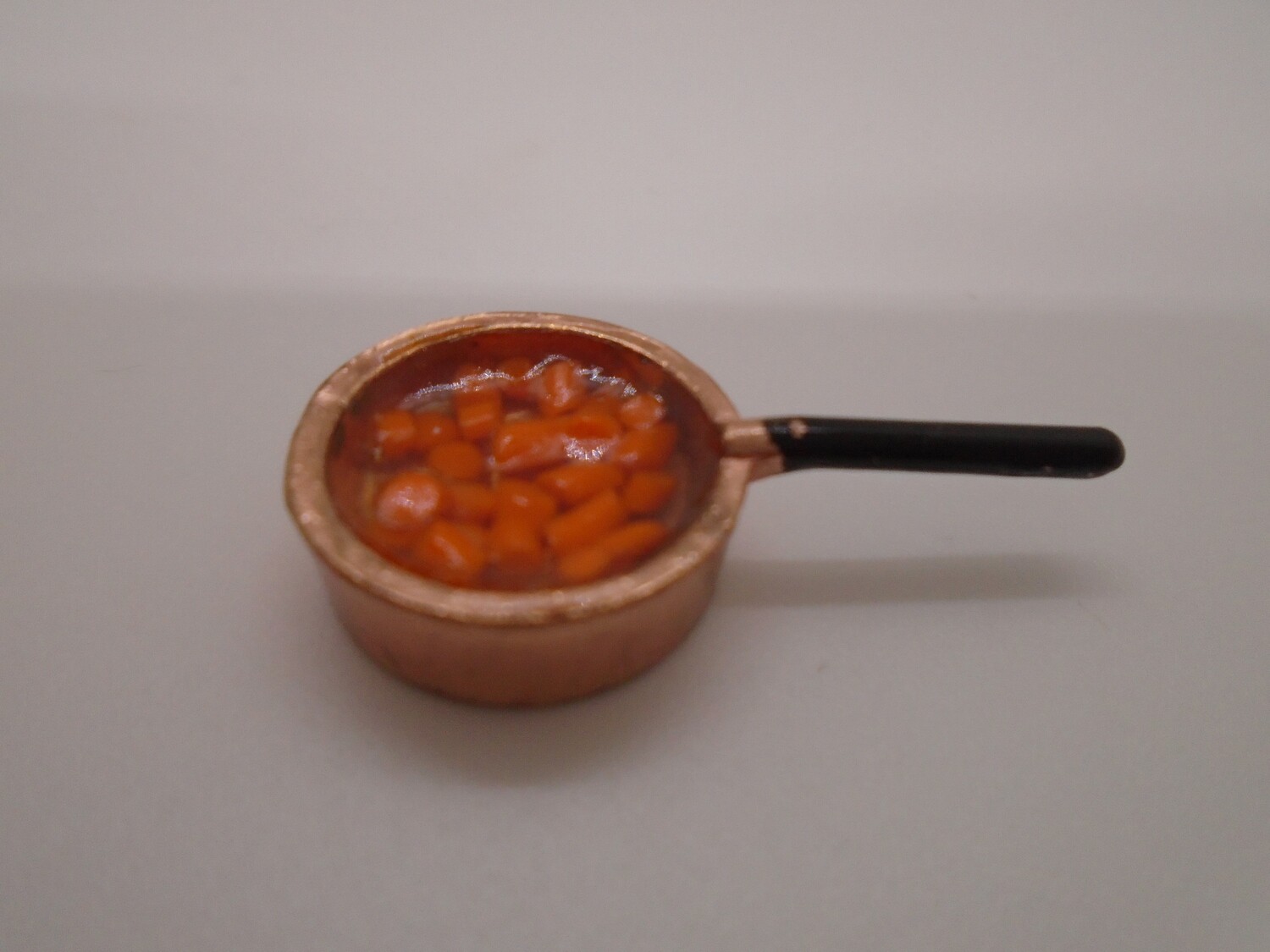 CARROTS IN WATER IN COPPER SAUCEPAN