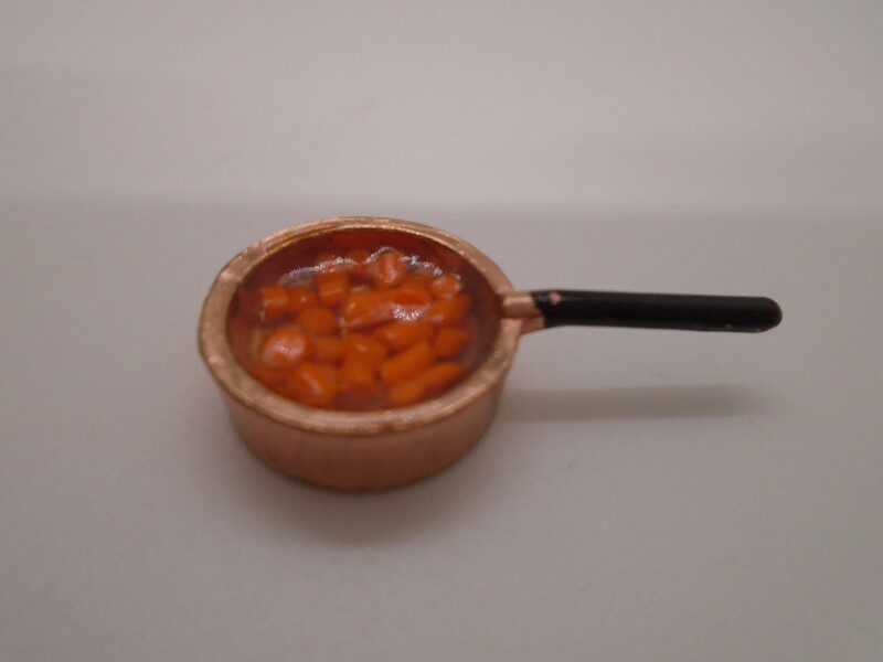 CARROTS IN WATER IN COPPER SAUCEPAN