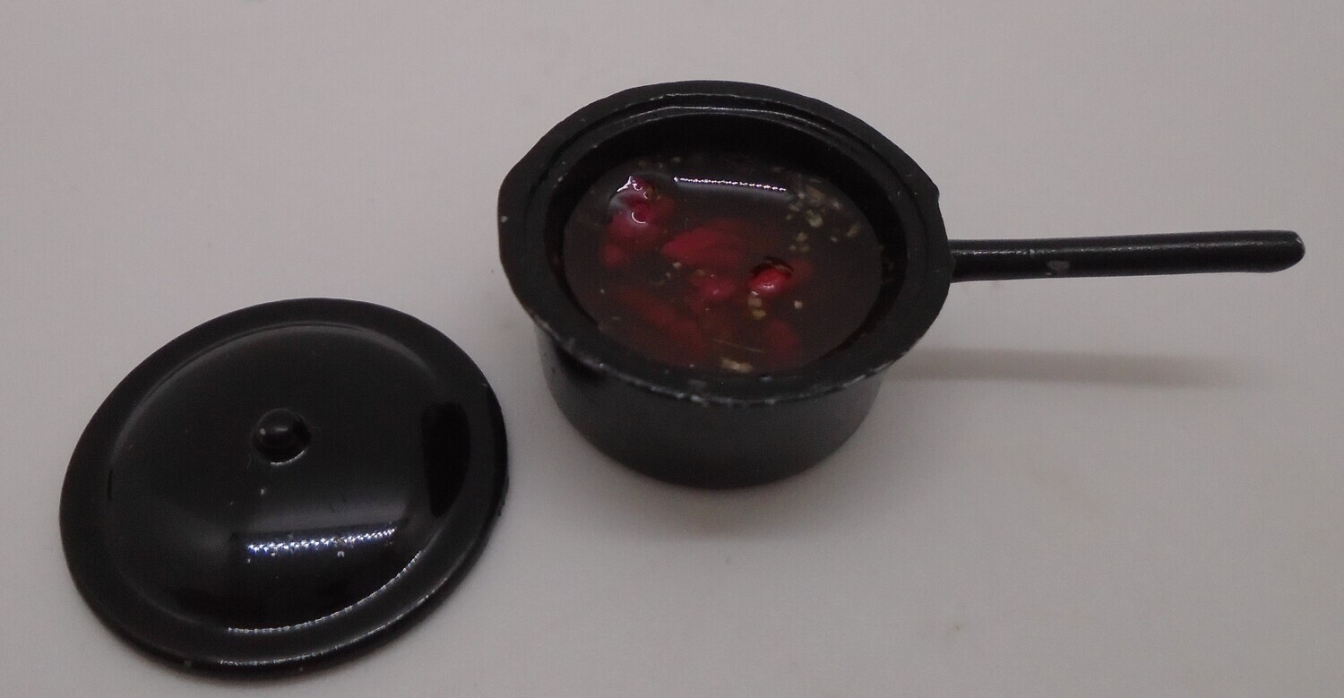BLACK SAUCEPAN OF TOMATOES  READY FOR PASTA SAUCE