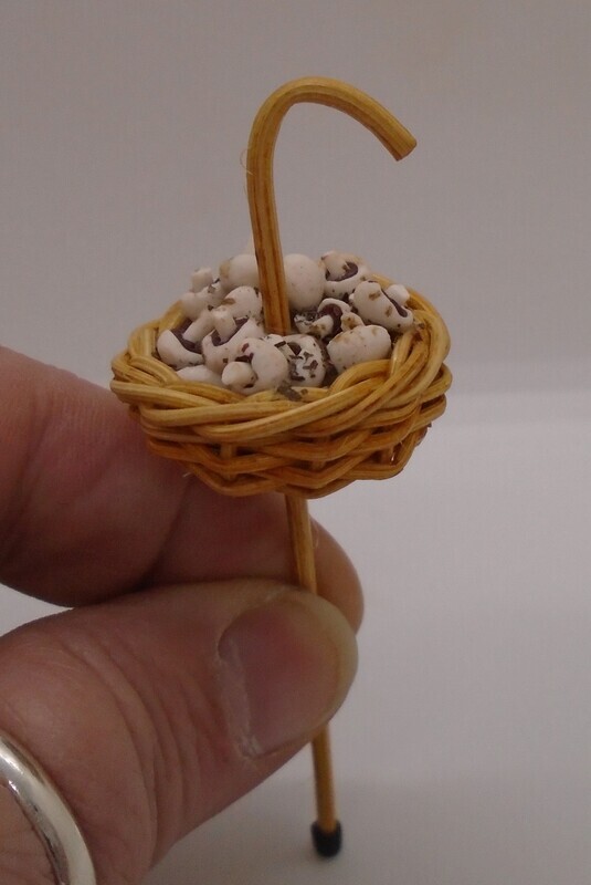 WALKING STICK WITH BASKET FILLED WITH MUSHROOMS