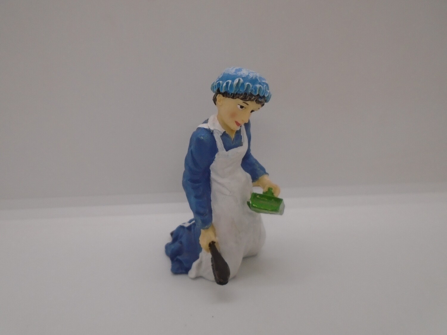 MAID SWEEPING WITH DUSTPAN AND BRUSH