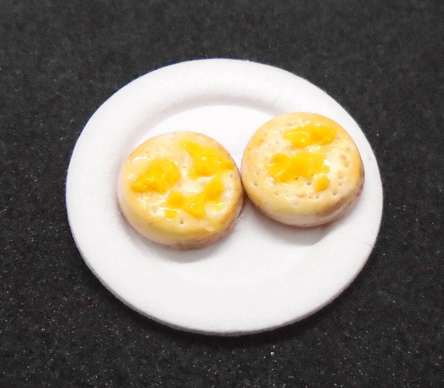 TOASTED BUTTERED CRUMPETS ON PLATE
