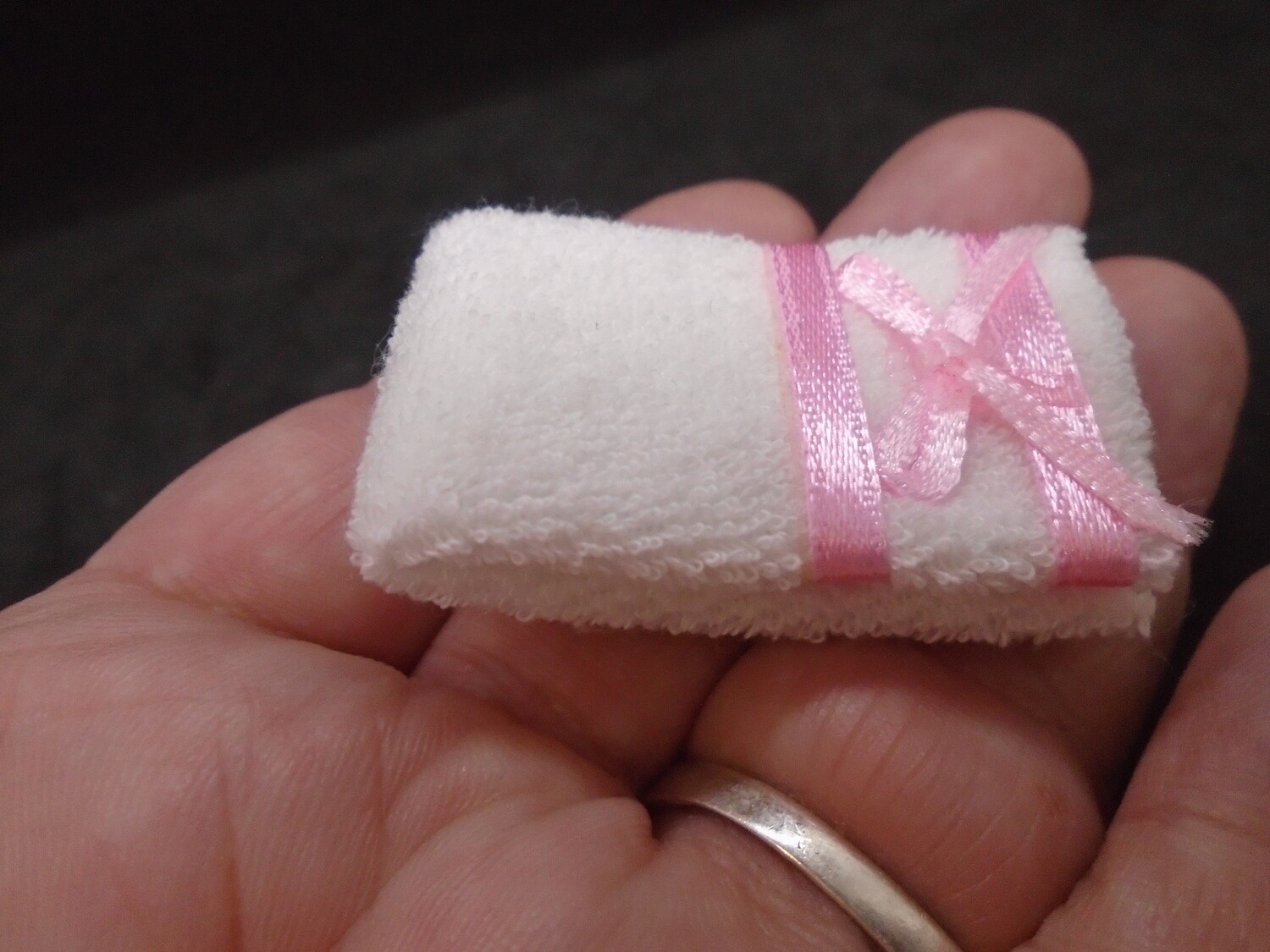 WHITE AND PINK FOLDED BATH TOWEL