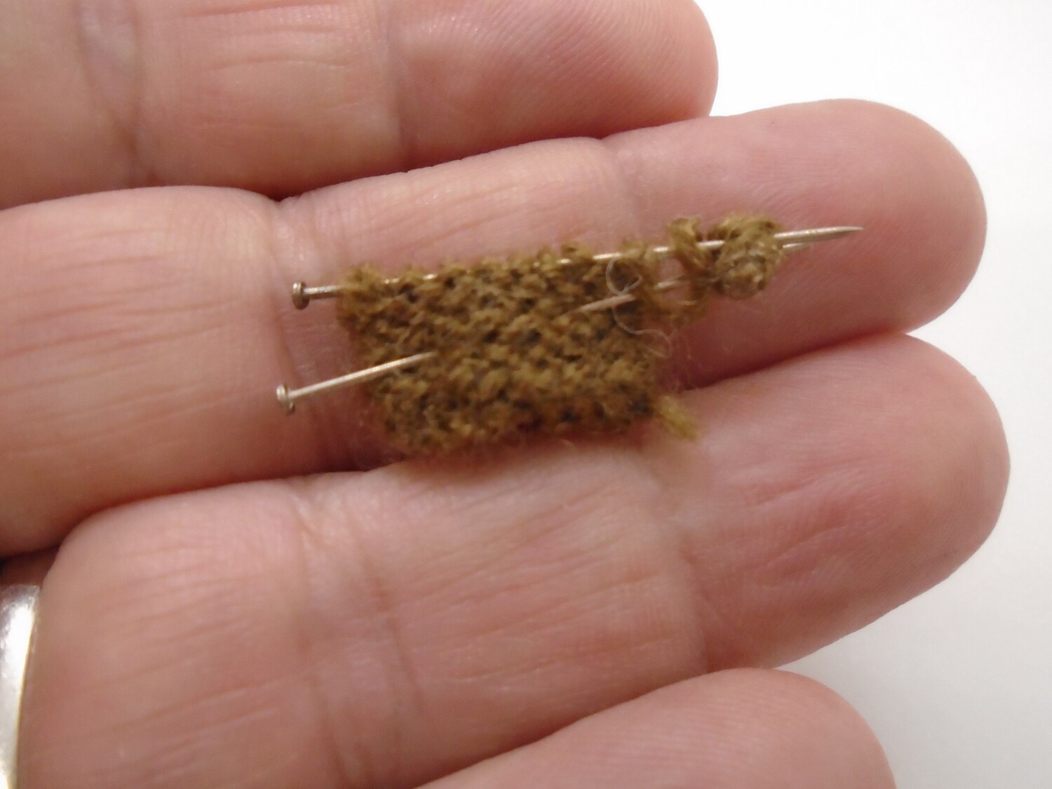 KNITTING ON NEEDLES WITH WOOL