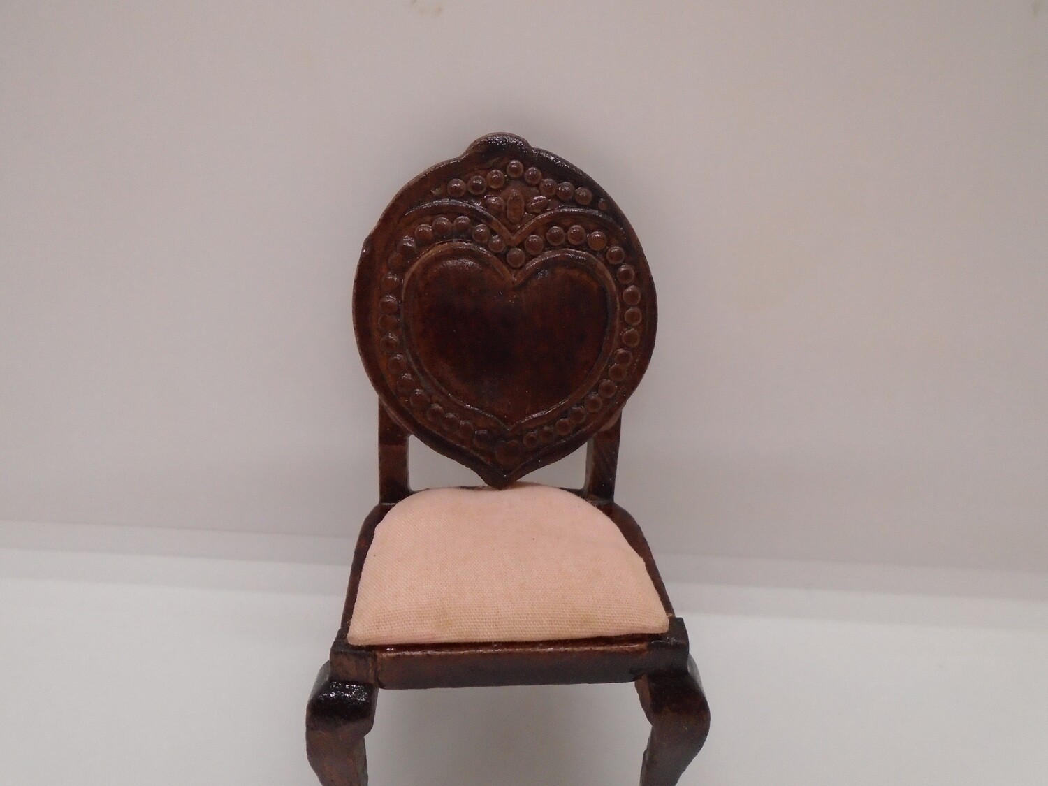 CARVED WOODEN CHAIR WITH LIGHT PEACH SEAT