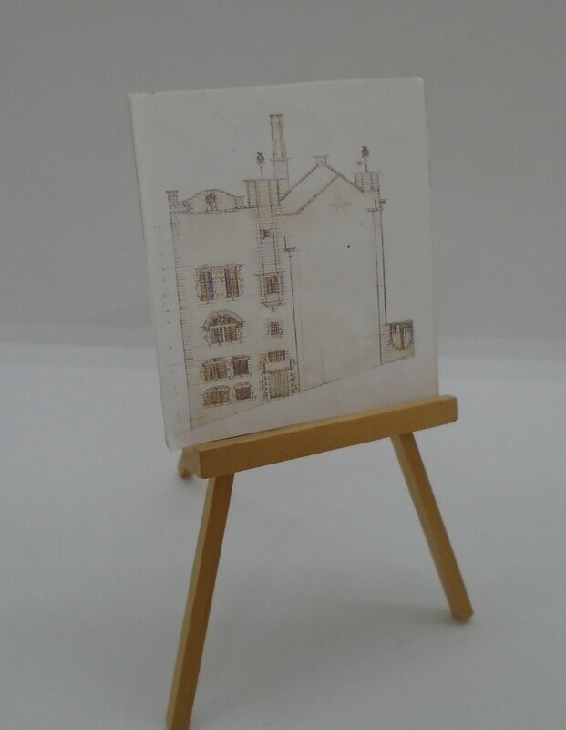 EASEL WITH DRAWING OF HOUSE