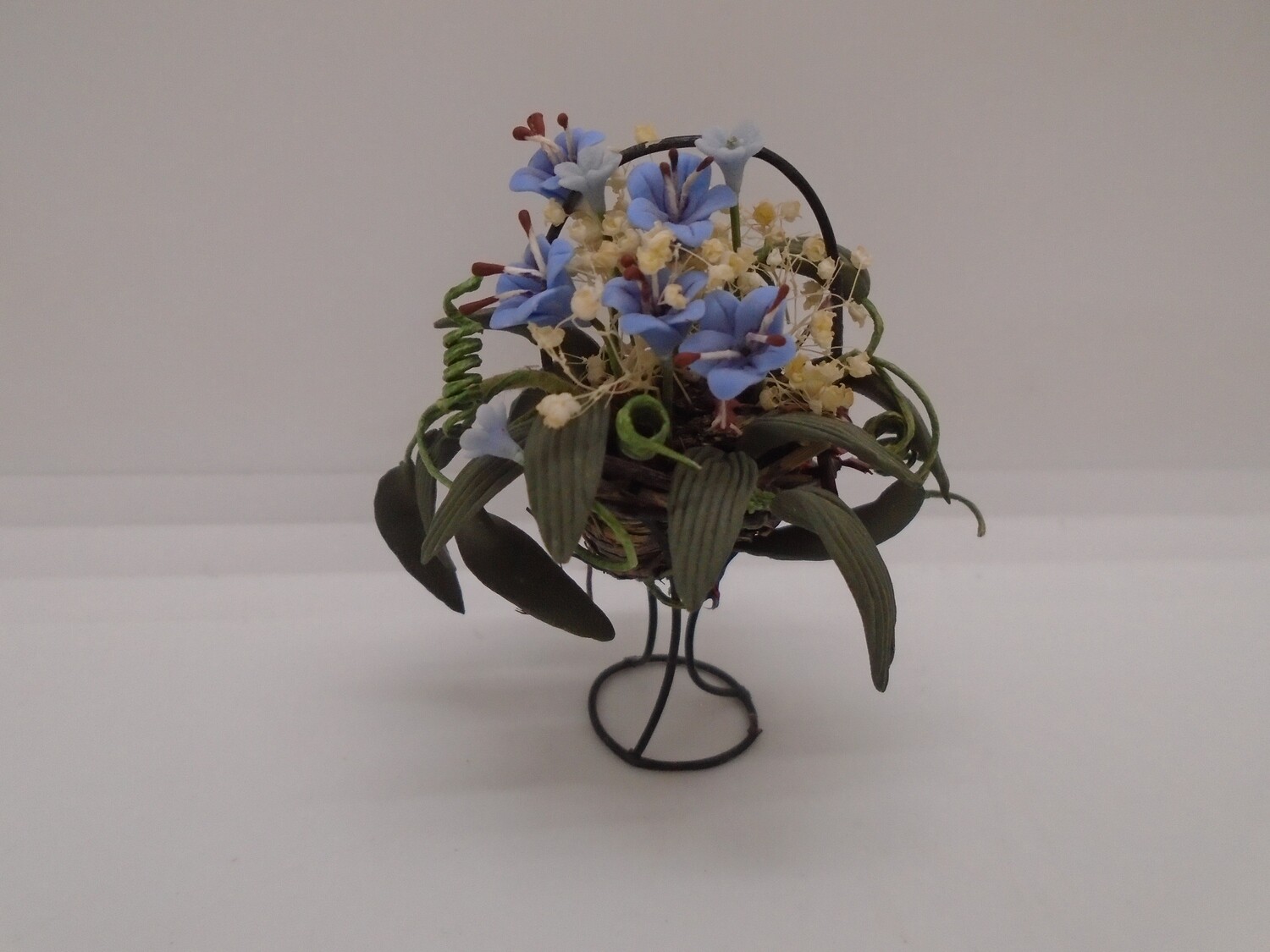 PLANT IN BASKET ON METAL STAND