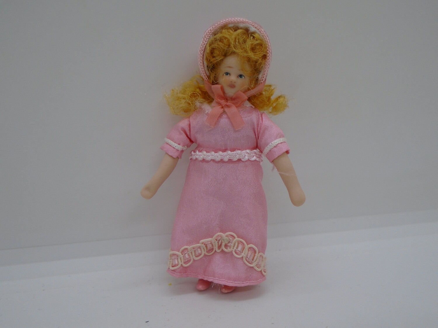 GIRL IN PINK DRESS AND BONNET