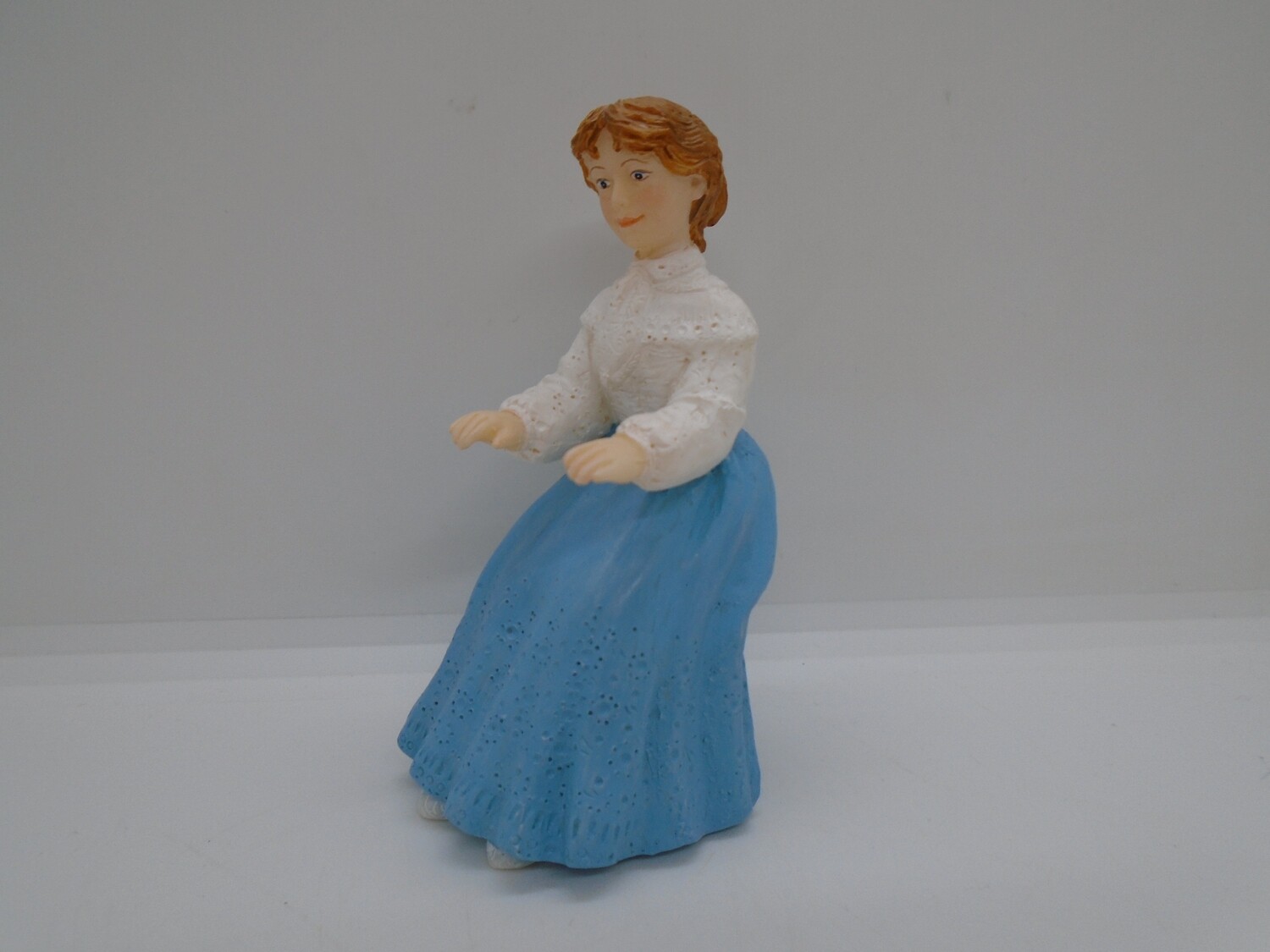 SITTING LADY IN BLUE SKIRT