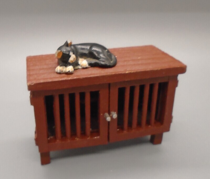 CAT ON A GUINEA PIG CAGE
