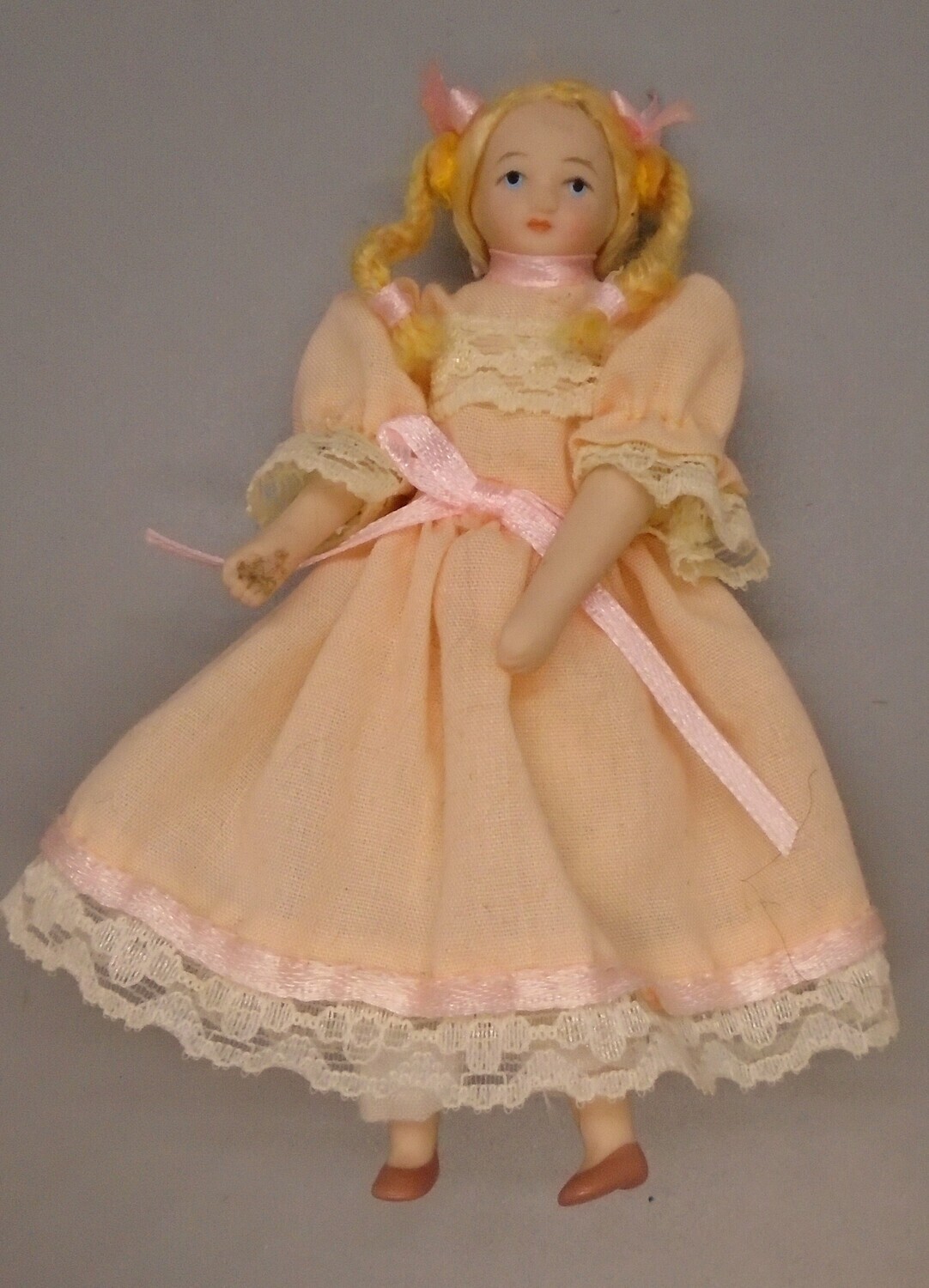 GIRL IN PEACH WITH PLAITS