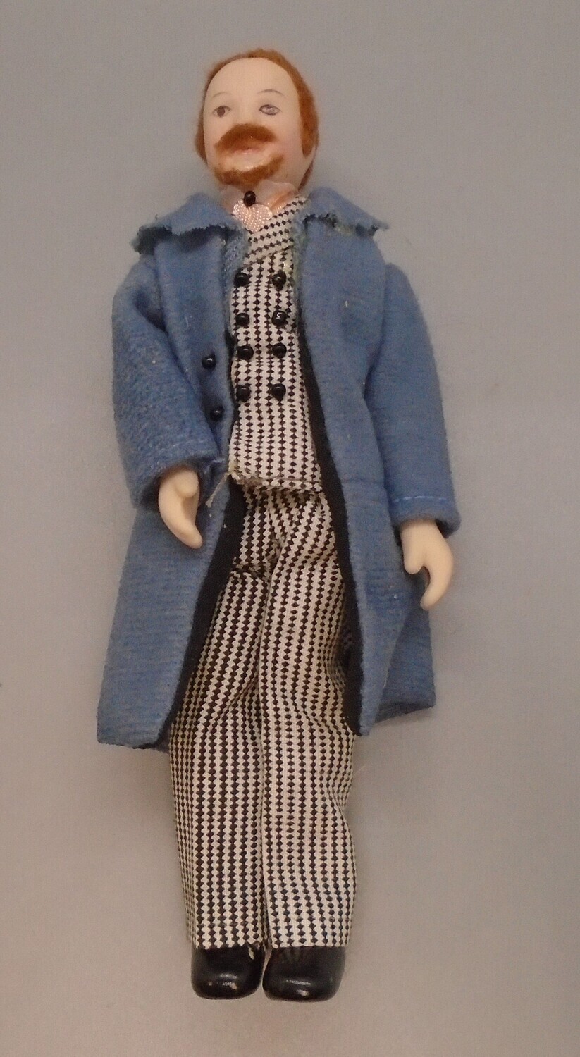 MAN IN DOGTOOTH SUIT AND BLUE COAT