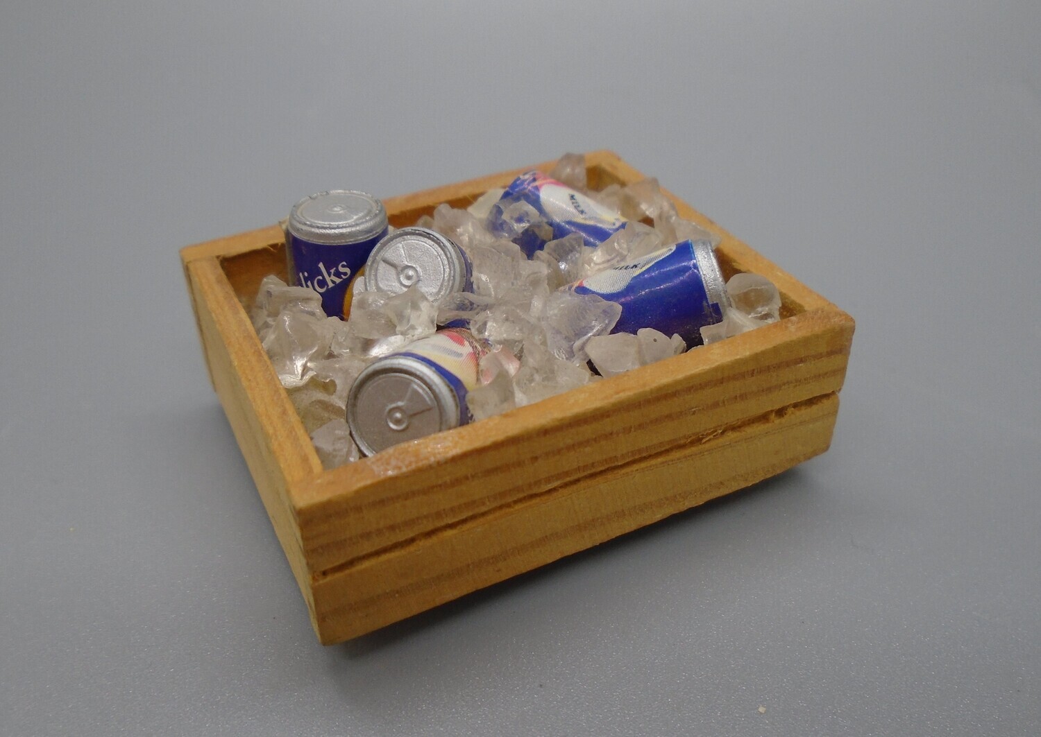 CRATE OF CANS IN ICE