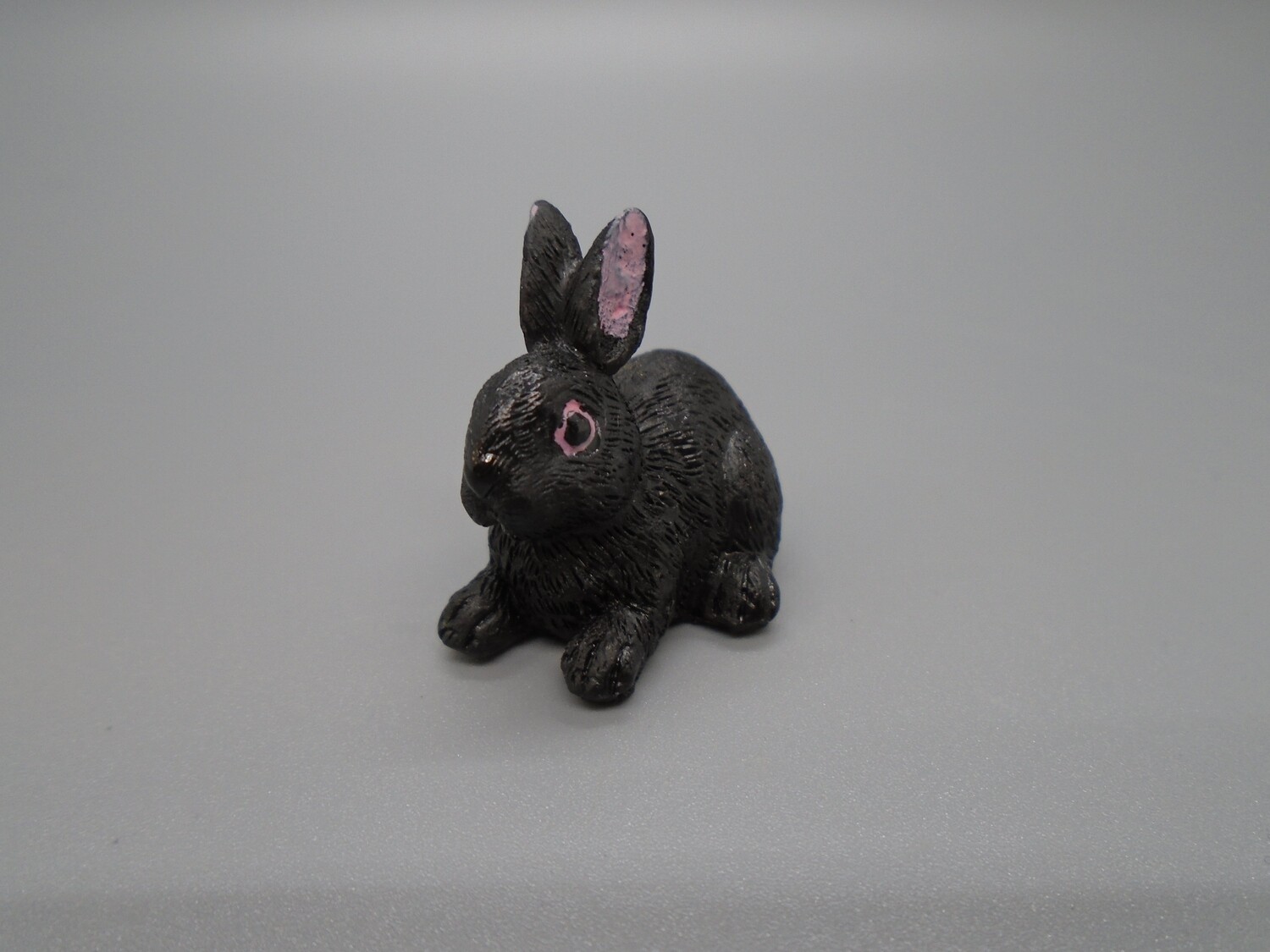BLACK RABBIT LYING
